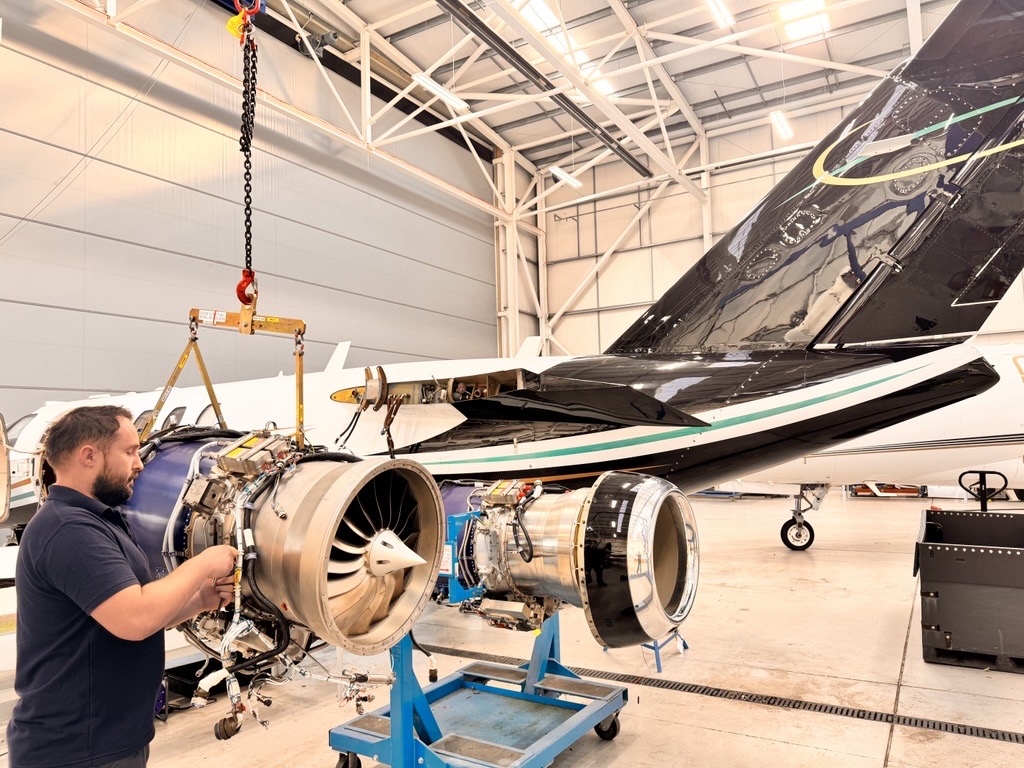 JMI engineer working on a removed FJ44 engine in the hangar.